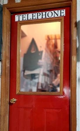 Customized lettering on a door to look like a British Telephone booth