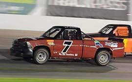 Race truck with custom lettering racing on a track Race truck with custom lettering racing on a track