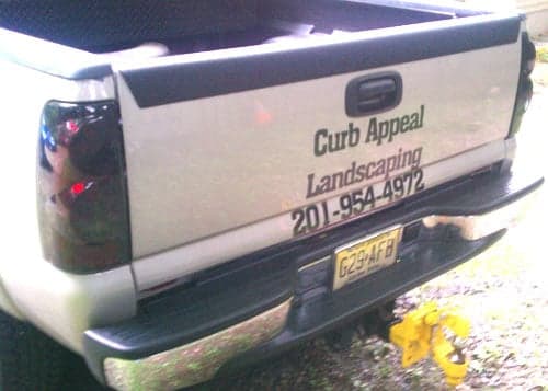 Custom vinyl lettering on a work truck.