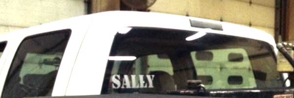 Vinyl lettering on a vehicle window Vinyl lettering on a vehicle window