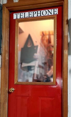 Customized lettering on a door to look like a British Telephone booth Customized lettering on a door to look like a British Telephone booth